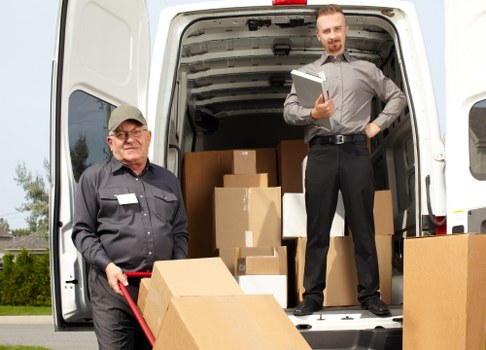 Packed household boxes and moving supplies ready for collection in West Hampstead