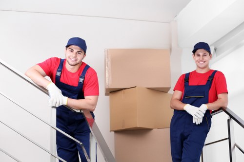 Professional movers carrying items through a West Hampstead apartment building