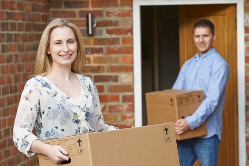 Household boxes and furniture being arranged for a West Hampstead move