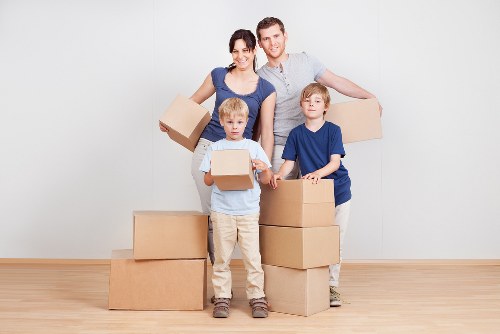 Loading furniture and boxes into a moving truck in West Hampstead