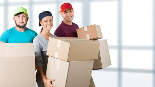 Furniture being carried through a flat building during a West Hampstead move