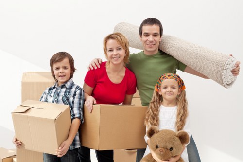 Local movers preparing large furniture for transport from a West Hampstead property