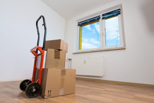 Packed moving boxes and wrapped furniture ready for collection